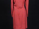 a red and black checkered dress on a mannequin stand