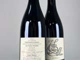 two bottles of wine sitting next to each other on a table