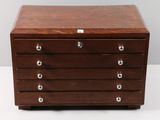 a small wooden chest of drawers with four drawers on each side