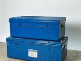 two blue boxes stacked on top of each other on the floor