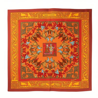 an orange and red square scarf with a picture of a man on a horse