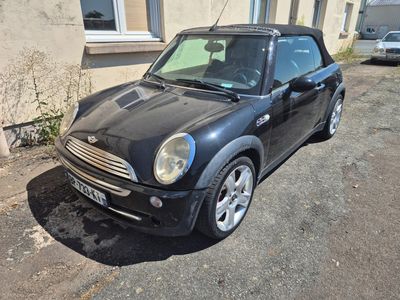a small black car parked in front of a building