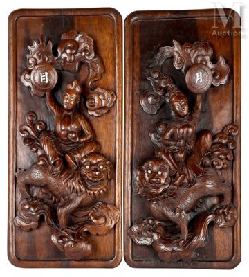 a pair of carved wood plaques depicting a dragon and a lion