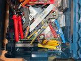 a blue tool box filled with various tools on a table