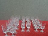 a lot of empty wine glasses on a red table