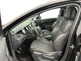 the interior of a car with the door open and the driver ' s seat down