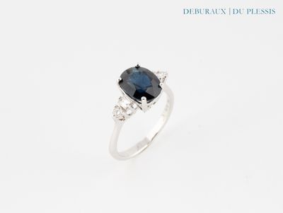 a blue sapphire and diamond ring on a white background