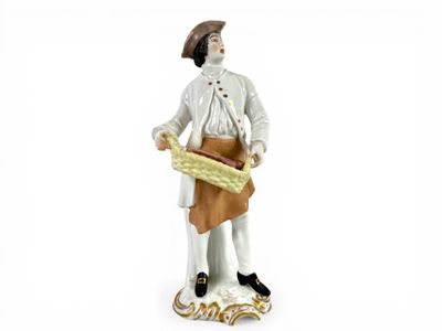 figurine of a man holding a basket of bread
