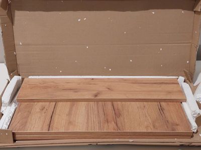 a cardboard box with a wooden floor inside of it