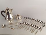 a lot of spoons and silverware on a table