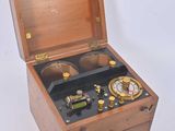 a small wooden box with a clock inside of it