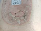 a close up of a vase with a label on it