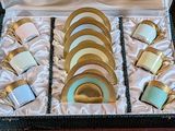 many cups and saucers in a box on a table