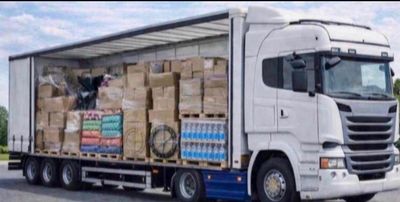 a semi truck with a large load of boxes on the back of it