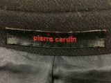 a close up of a black suit with a red label on it