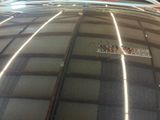 a reflection of a train on the hood of a car