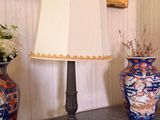 two vases and a lamp on a table in a room