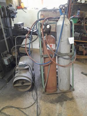 a fire extinguisor sitting in a garage next to a fire hydrant