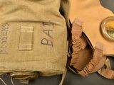 a bag with a gas mask on it next to a pair of gloves