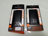 packaging of two black and orange cell phones sitting on top of a white table