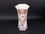 a vase with a floral design on it on a black background