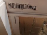 a white refrigerator with a bar code on it