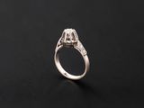 a white gold engagement ring with a round brilliant cut diamond set in the center