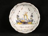 a white bowl with a picture of a woman and a bird on it