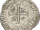 an old silver coin with a cross on it