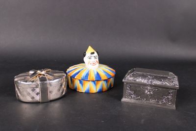 a small box with a clown face on it next to a small box with a clown face on it