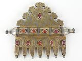 an image of a silver and gold comb with red stones on it