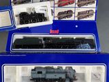 two boxed boxed trains are sitting on display in a blue box