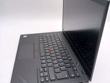 a black laptop with a red button on the keyboard