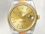 une image représentant une montre Rolex dorée et argentée sur fond blanc