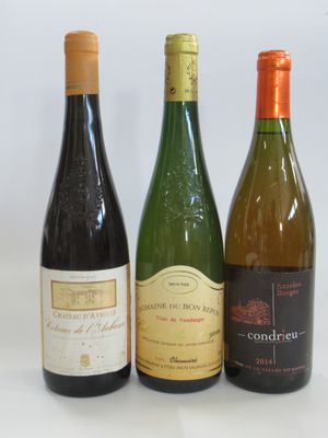 three bottles of wine are lined up on a white surface