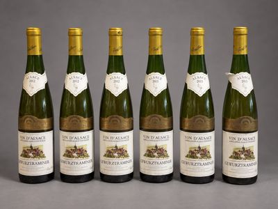 six bottles of wine are lined up in a row