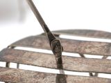a close up of a piece of metal with a piece of wood sticking out of it