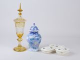 two vases and a small vase on a white surface