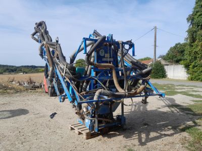 a blue machine that is sitting in the dirt
