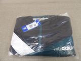 a black shirt wrapped in a plastic bag on the floor