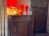 a wooden cabinet with a red lamp on top of it