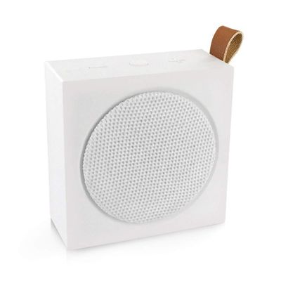 a close up of a white speaker on a white surface