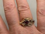 a woman ' s hand with a gold ring on it