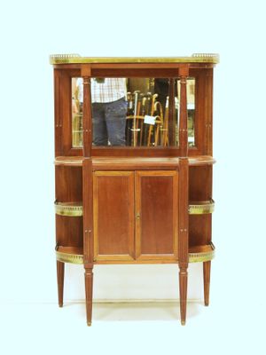 a wooden cabinet with a mirror on top of it