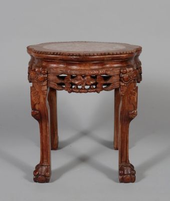 an old wooden table with a marble top and carved legs