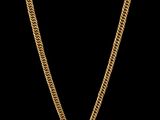un collier en or composé d'une chaîne et d'un pendentif, sur fond noir