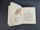 an open book with a drawing of a woman on it
