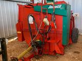 une machine rouge et verte qui est garée dans la poussière