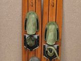 pair of skis sitting on top of a tiled floor next to a wall
