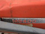 a close up of a red tractor with a number plate on it